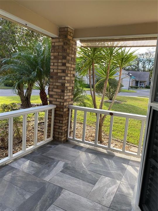 Tiled front porch under roof.