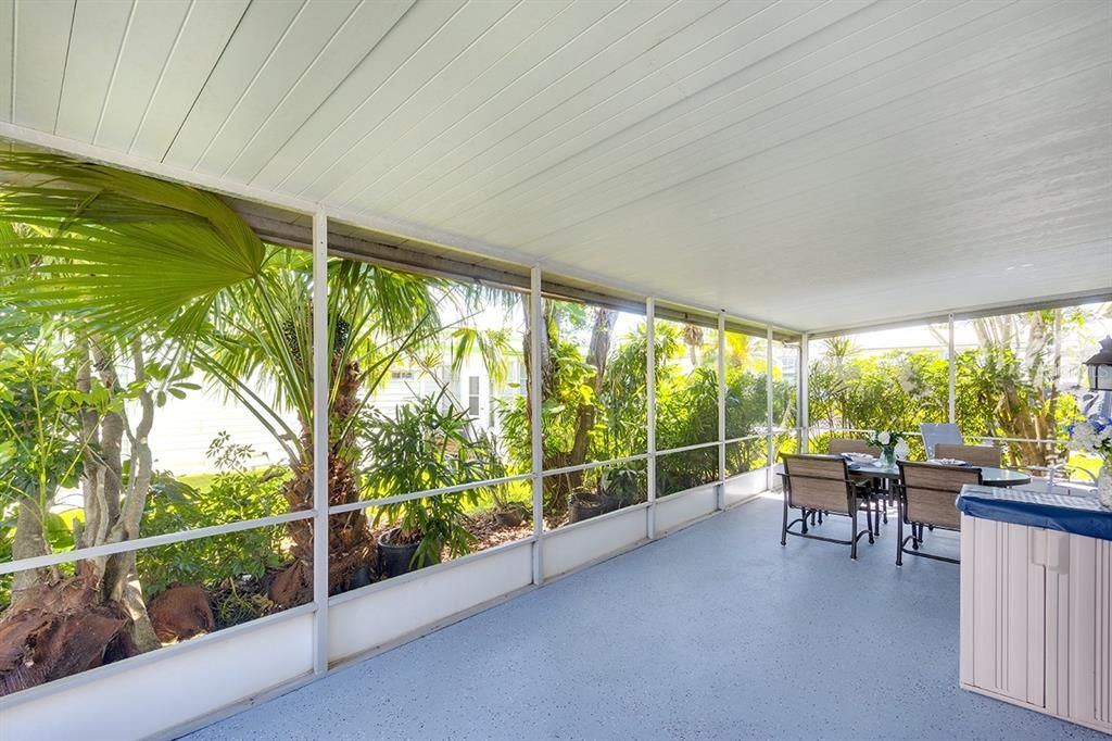 Tranquil screened lanai with lush tropical plantings...