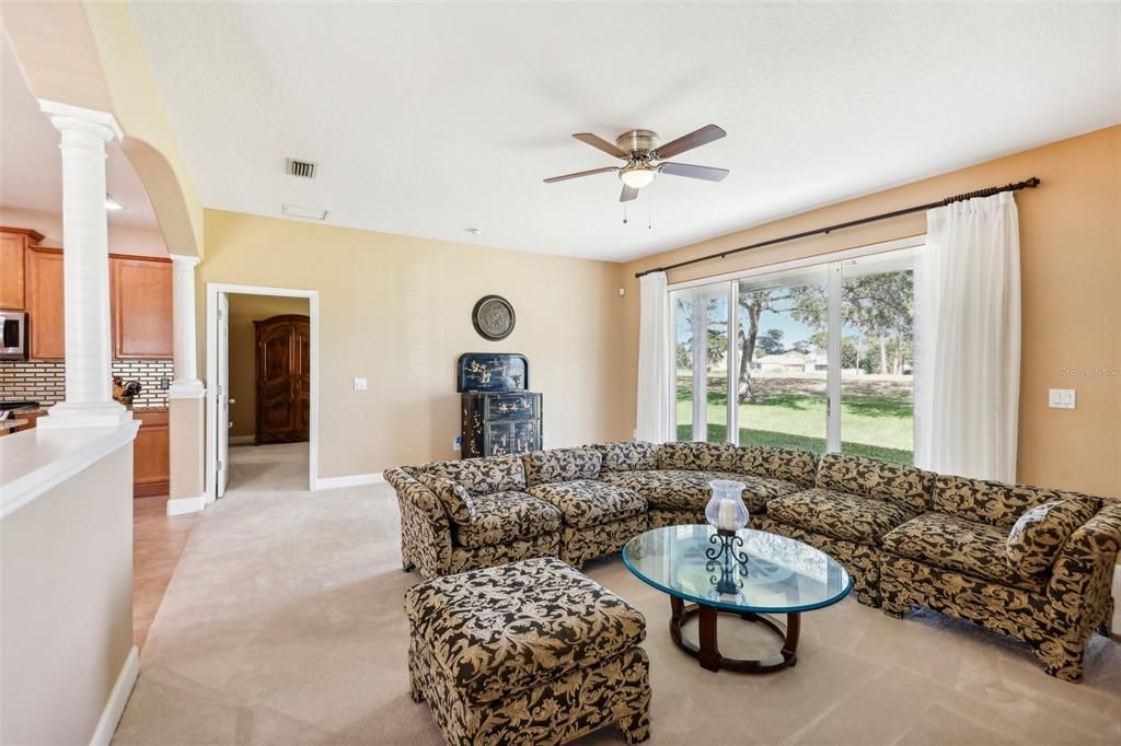 Great room with sliding doors out to the covered patio with peaceful views