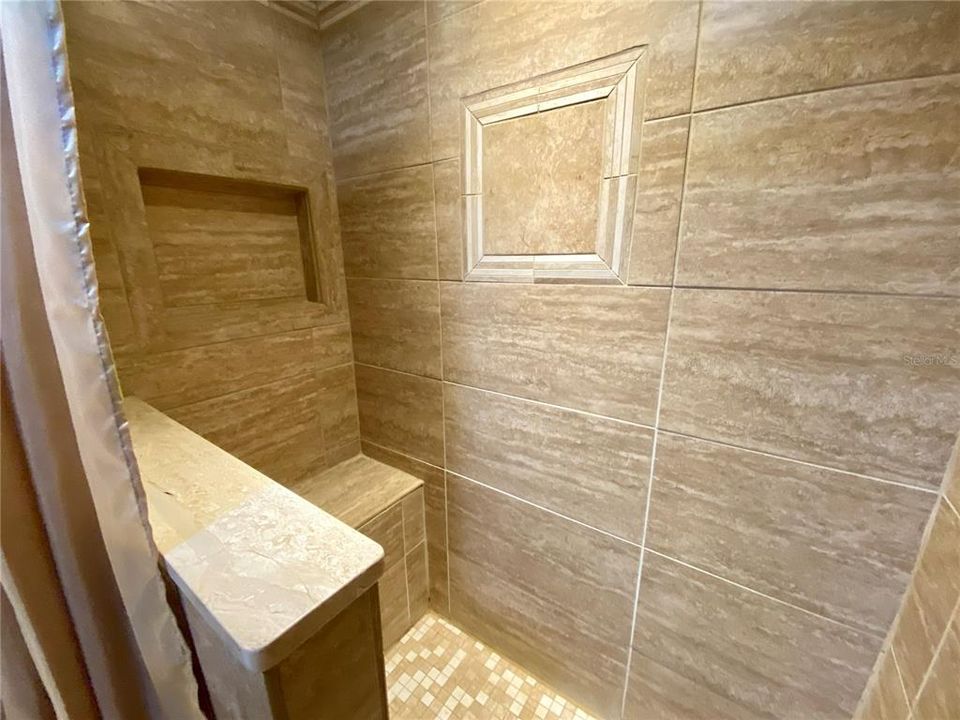 Elegant tiled Shower with nook and bench