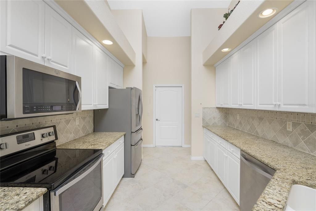 Kitchen with door to garage beyond.