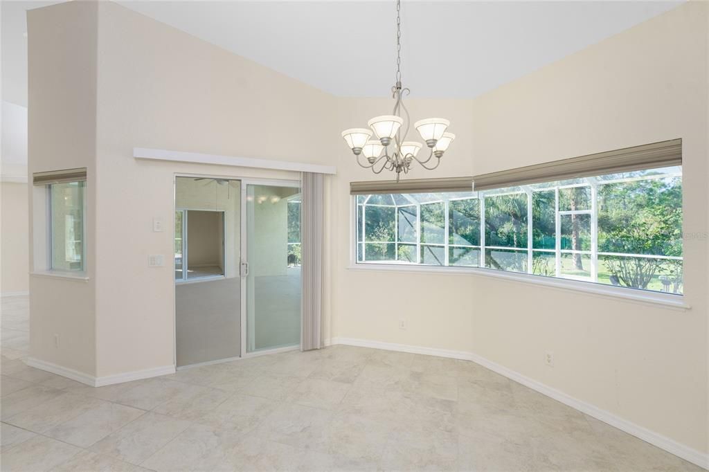 Dinette with window & sliders to Lanai, plus expansive mitered glass to take in the view.