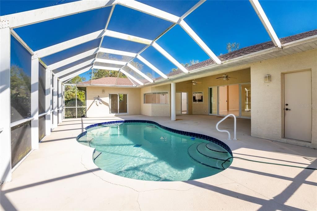 Pool screen enclosure is 44' wide with Bedroom 2 beyond & separate pool bath access from door to right.