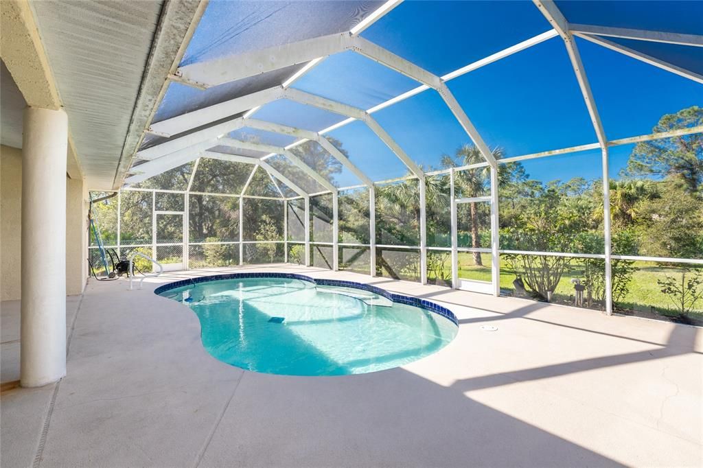 Pool with private backyard beyond