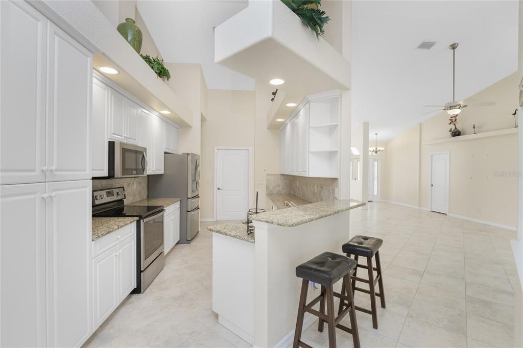 Kitchen adjacent to Great Room. Notice the tall pantry cabinet & raised breakfast bar.