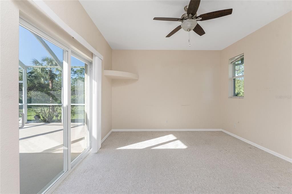 Rear Bedroom 2 with slider to pool & backyard beyond.