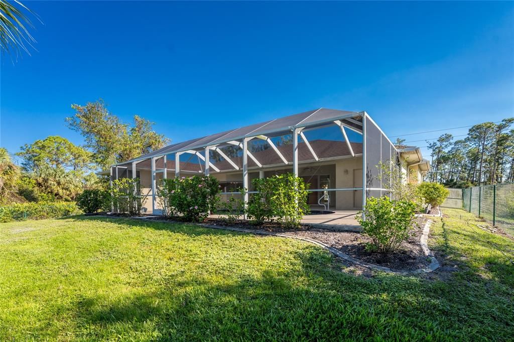 Rear of home with extensive pool area.