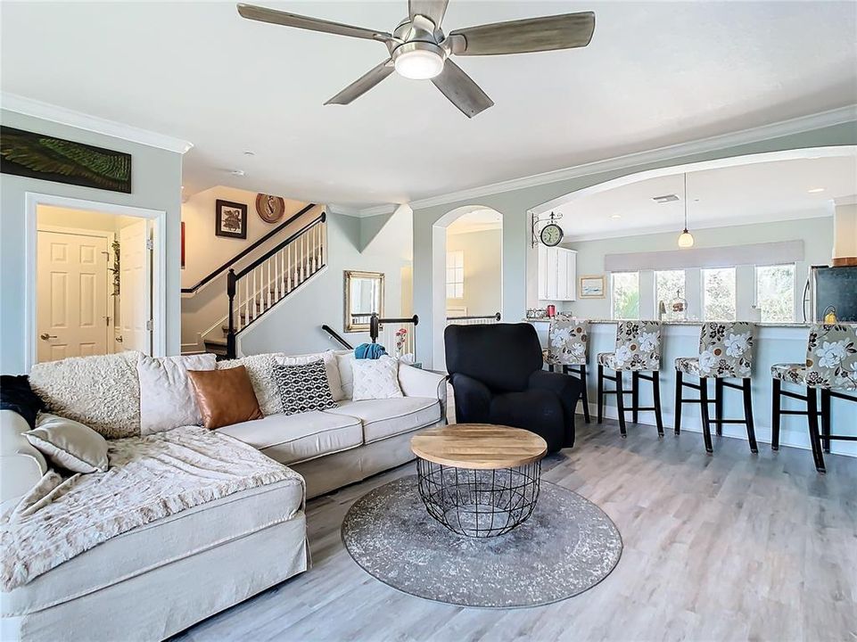 This shows the other side of the living room looking to the stairs and the 1/2 bath