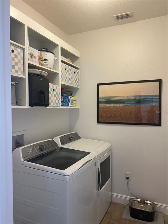 Laundry room with shelves.