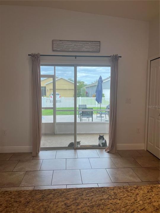 Back sliding doors to screened in patio and outdoor living space.