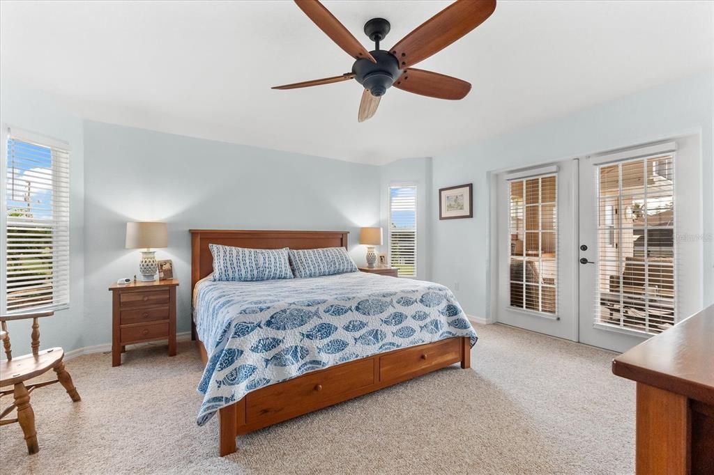 Relaxing Large Primary Bedroom Featuring French Doors to the Lanai