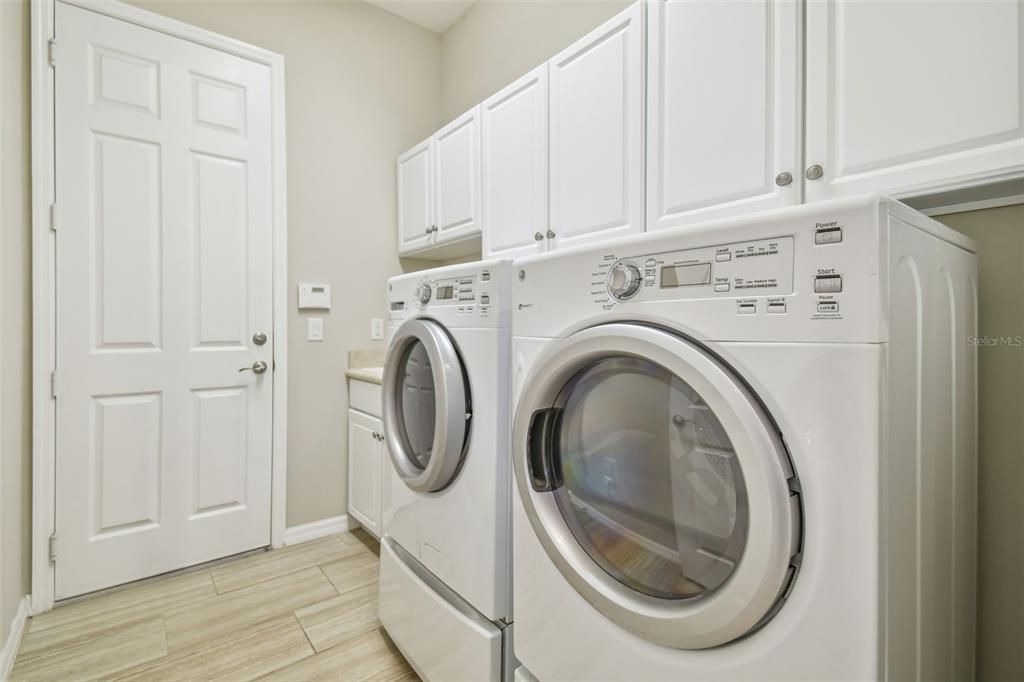 Laundry sink and washer dryer off of 2 car garage