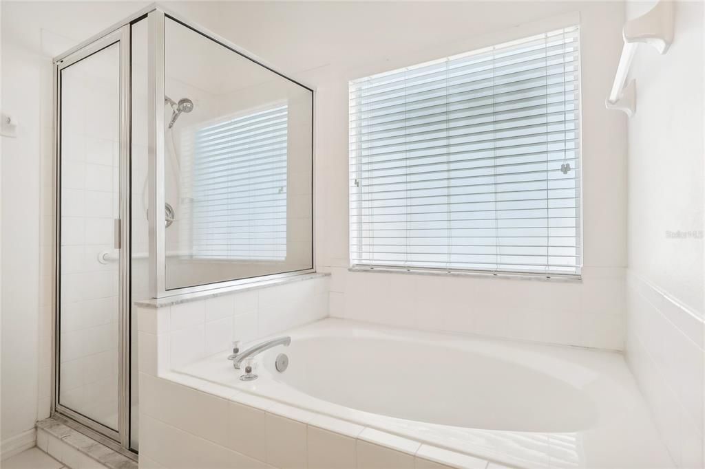 Soaking tub & separate shower in the primary bath.