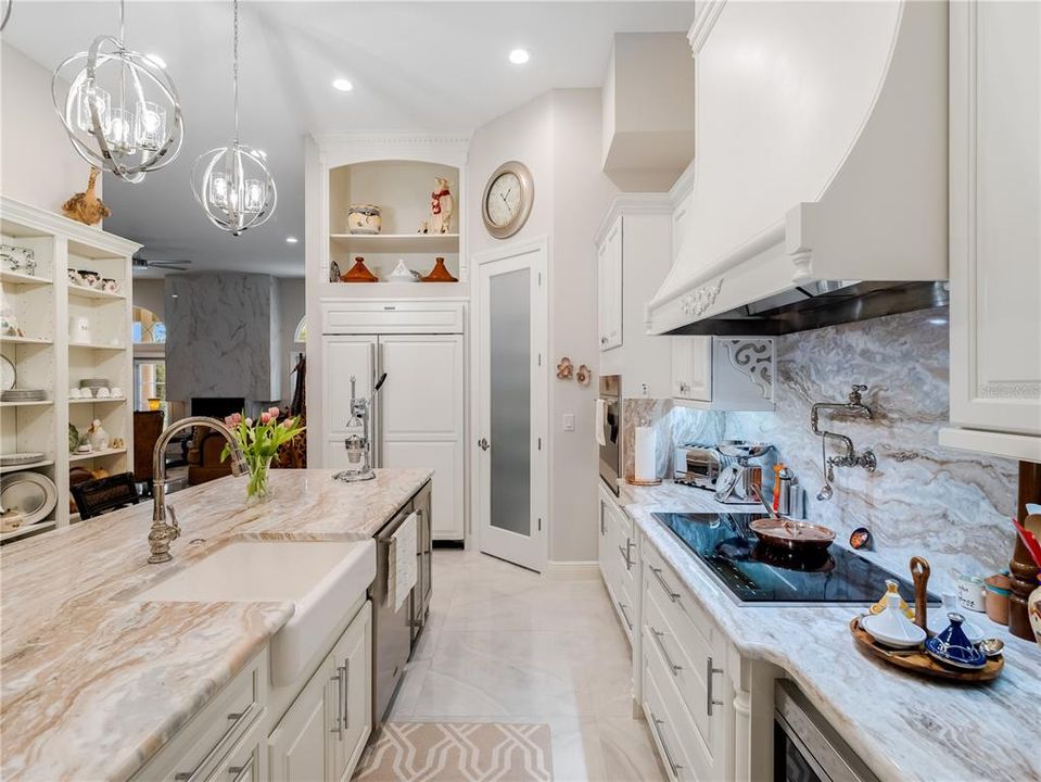 Kitchen with Sub Zero Refrigator, Pantry, and cooktop with pot filler