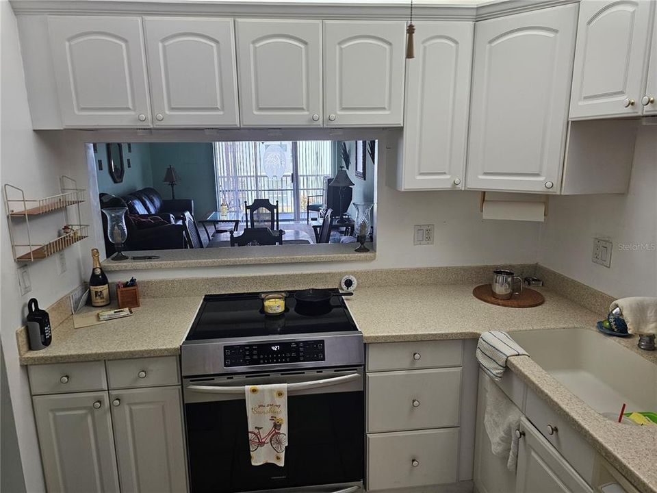 From Kitchen viewing into living area, Sliding door and balcony.