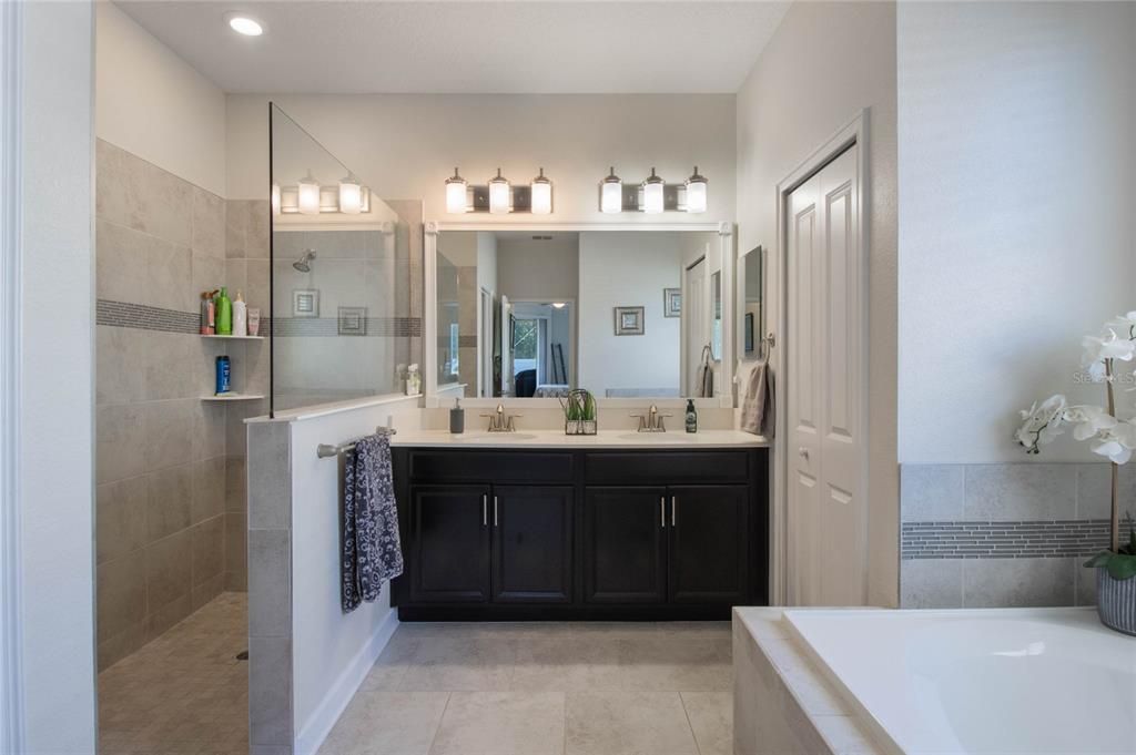 Primary Bathroom with Dual Sinks, Linen Closet, Water Closet and Handicapped Accessible Shower