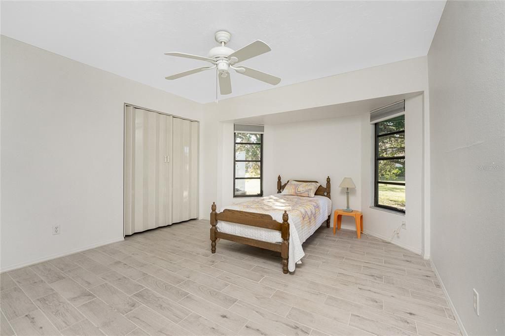 Bedroom #3 features a 2' bump out, a ceiling fan and tiled flooring.