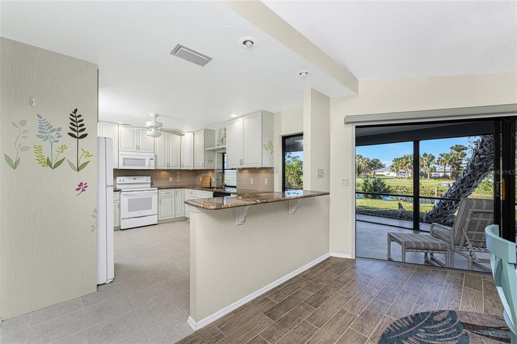 The granite counter top provides extra space or a possible breakfast bar.