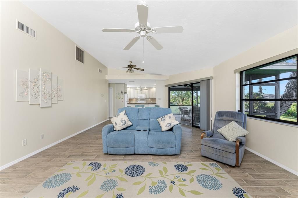 A direct view of the living room into the dining room and kitchen.