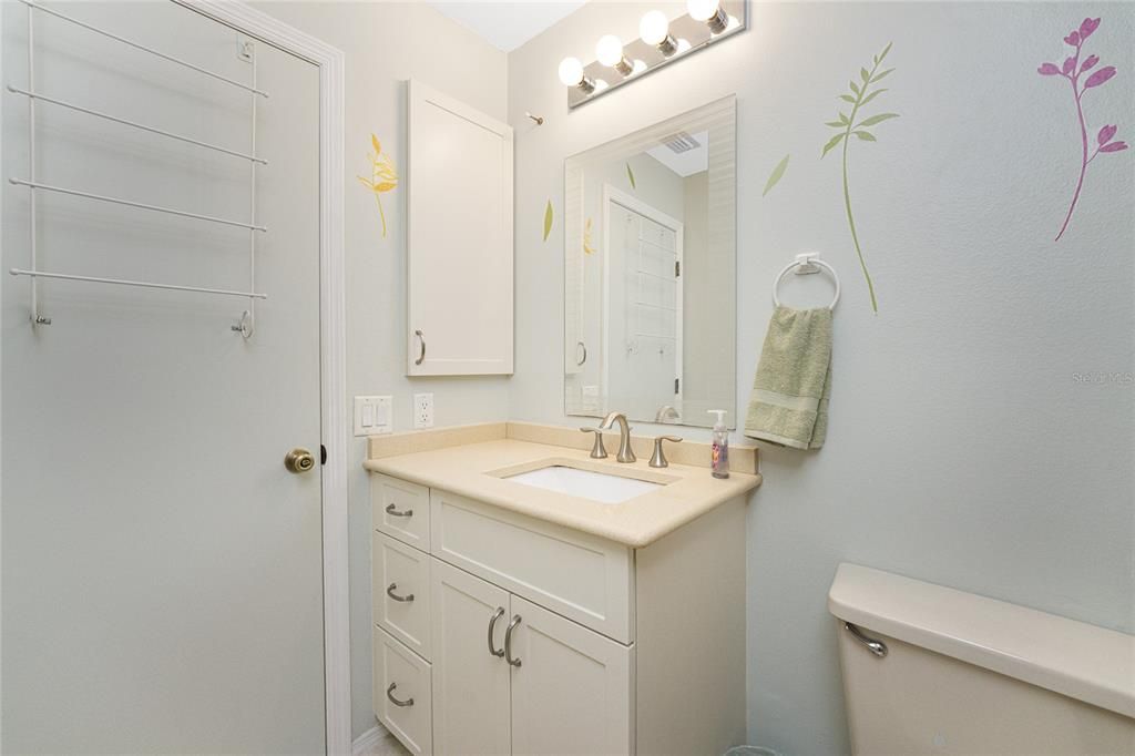 The guest bathroom has a medicine cabinet for extra storage.