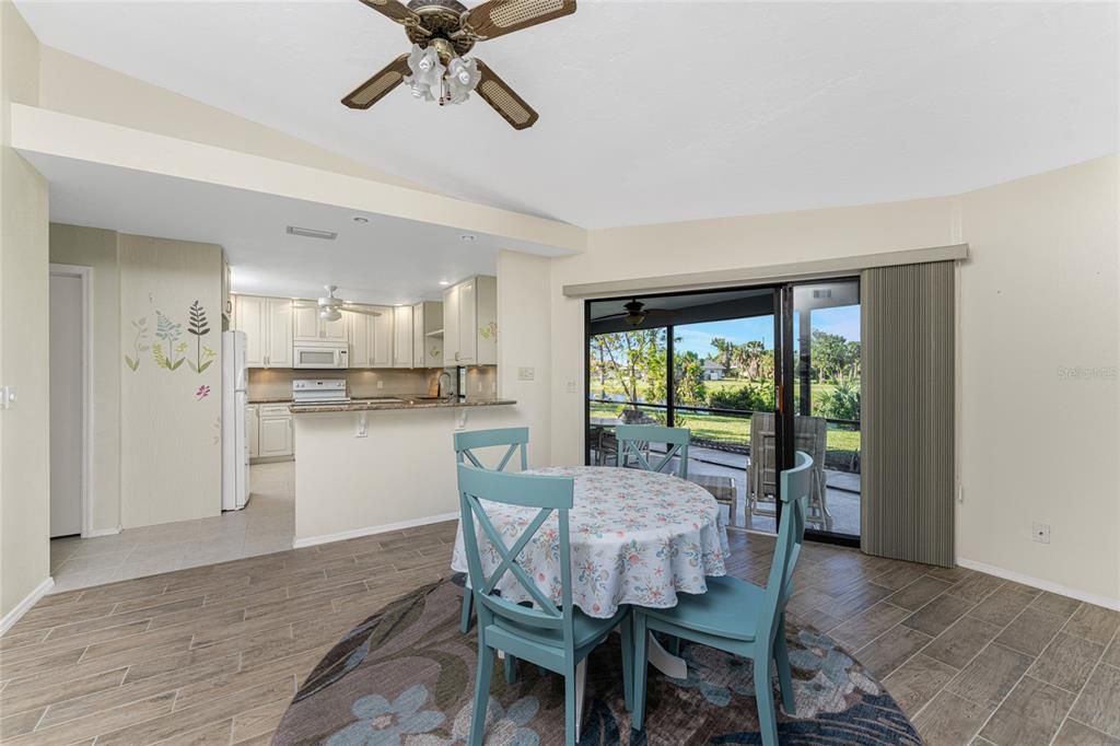 The dining room is located between the living room and kitchen with sliding glass doors to the lanai.