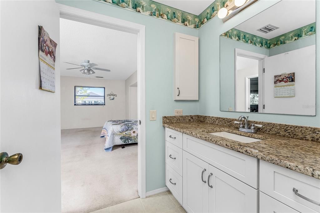 The master bathroom has tiled flooring and a medicine cabinet