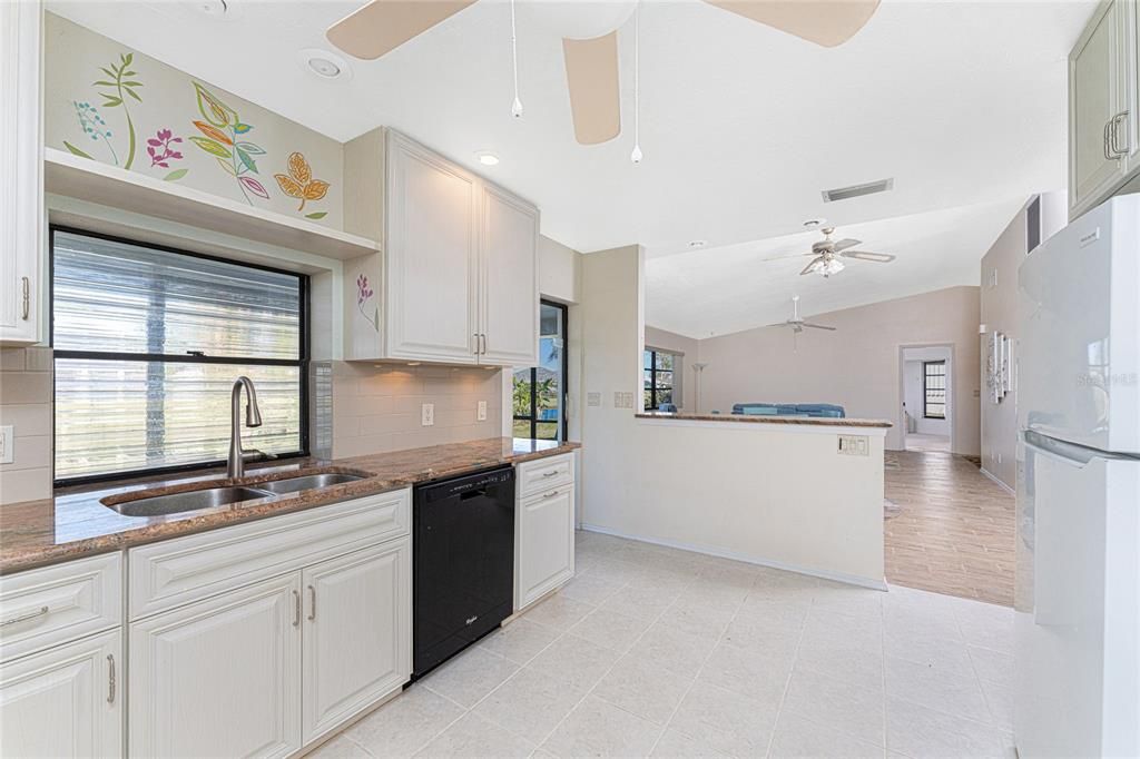 The stainless steel sink is located in front of a window that provides extra light.