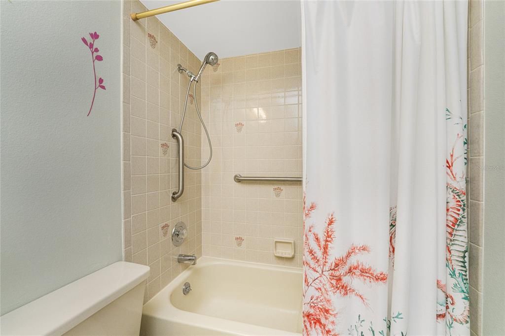 The bathroom features a shower/tub combo.