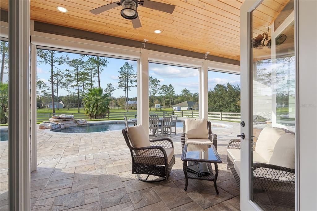 LOOKING OUT TO POOL FROM LANAI - ELECTRIC SCREENS ARE UP AND HIDDEN