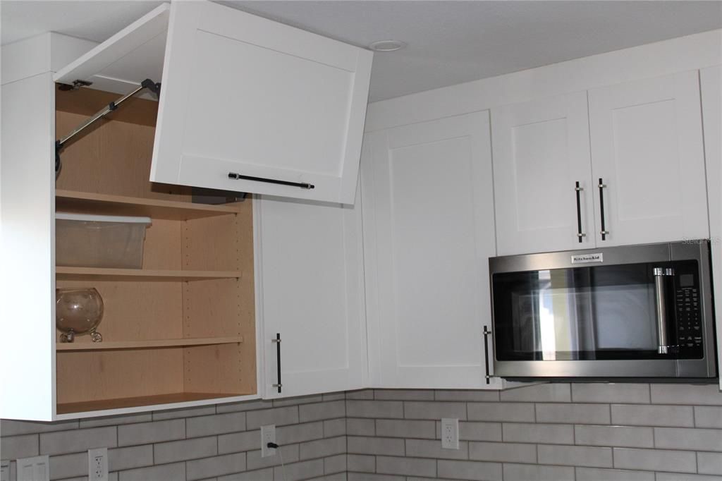 Swing-up kitchen cabinets