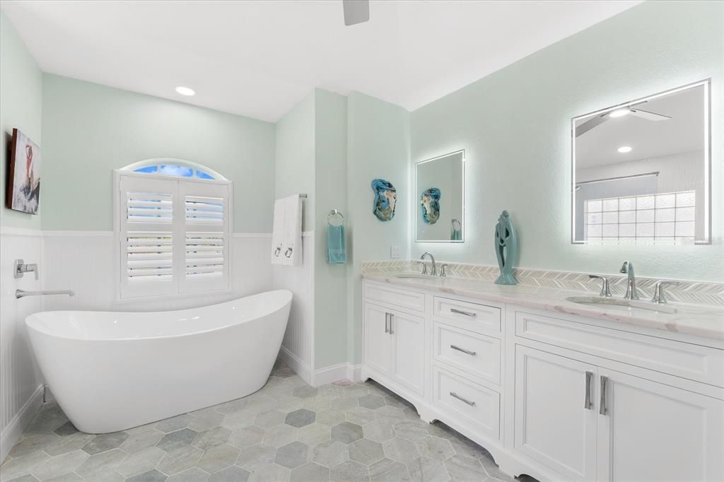 Soaking tub in Master Bathroom, double vanities and lovely plantation shutters.