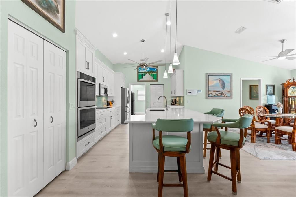 Kitchen with island featuring high-end appliances and large pantry / closet.