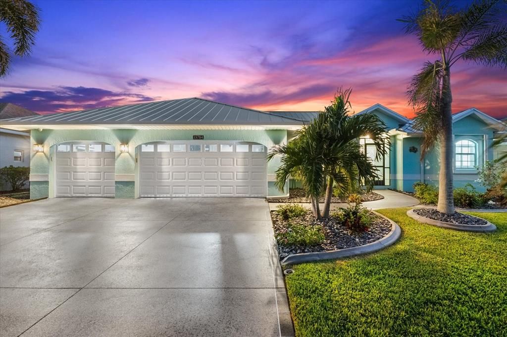 Mature landscaping surrounds the custom driveway.