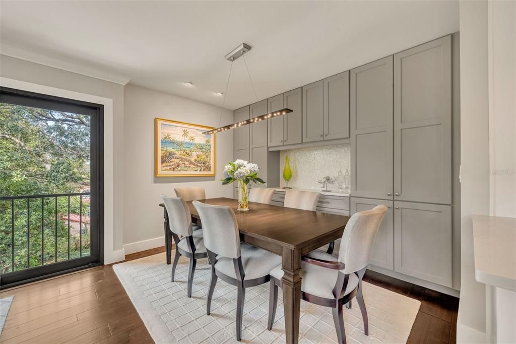 Formal dining area with custom built-ins and dramatic lighting.