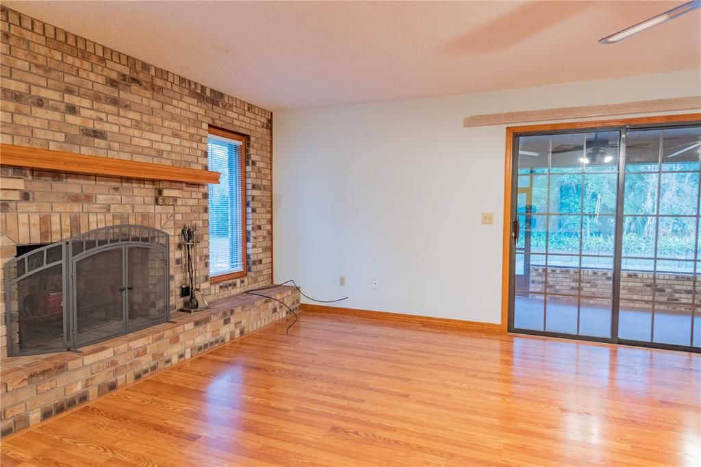 Family room fireplace and exit to screen porch