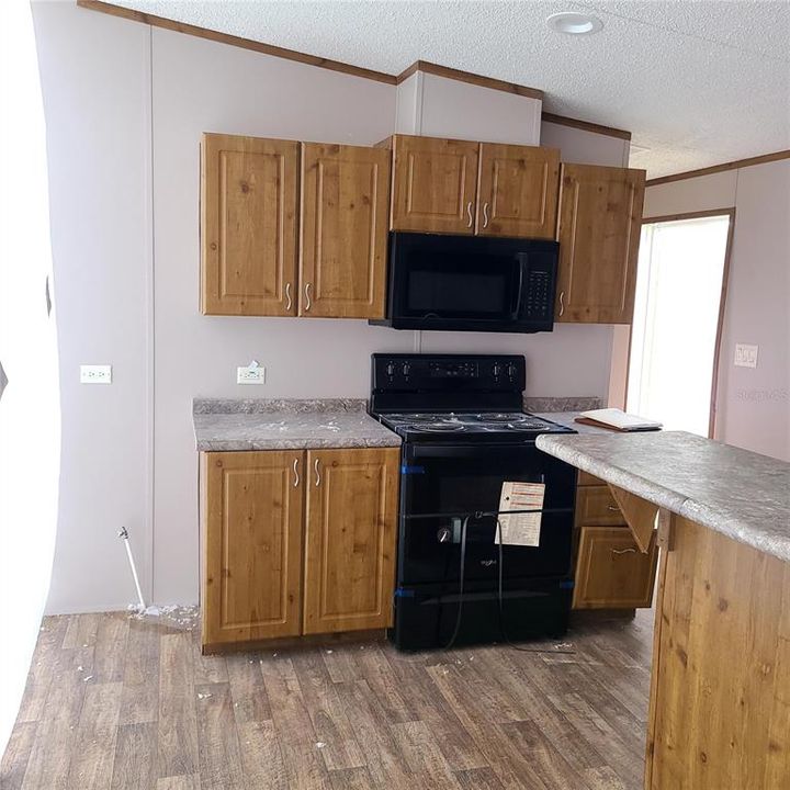 Kitchen with stove and microwave.