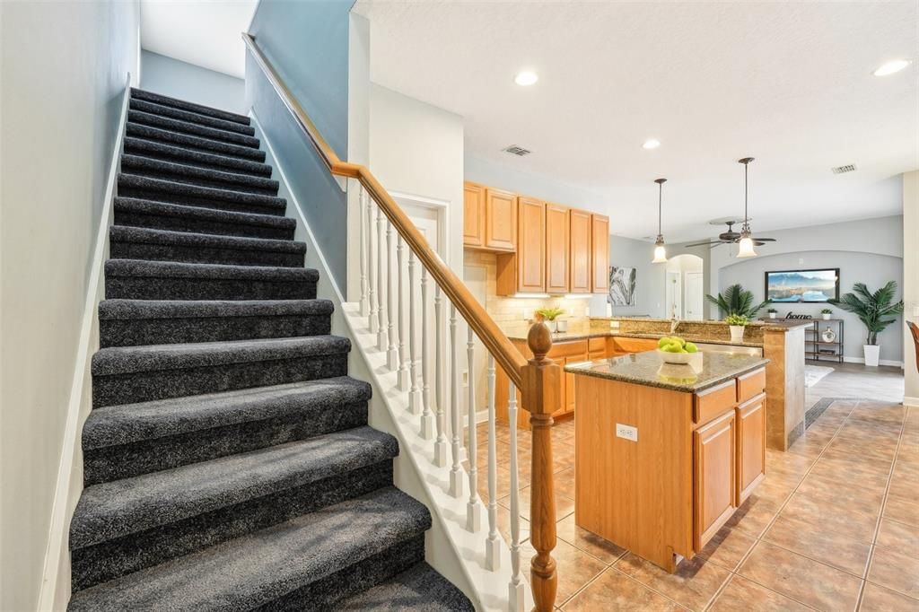 Stairs leading up to bonus & 5th bedroom