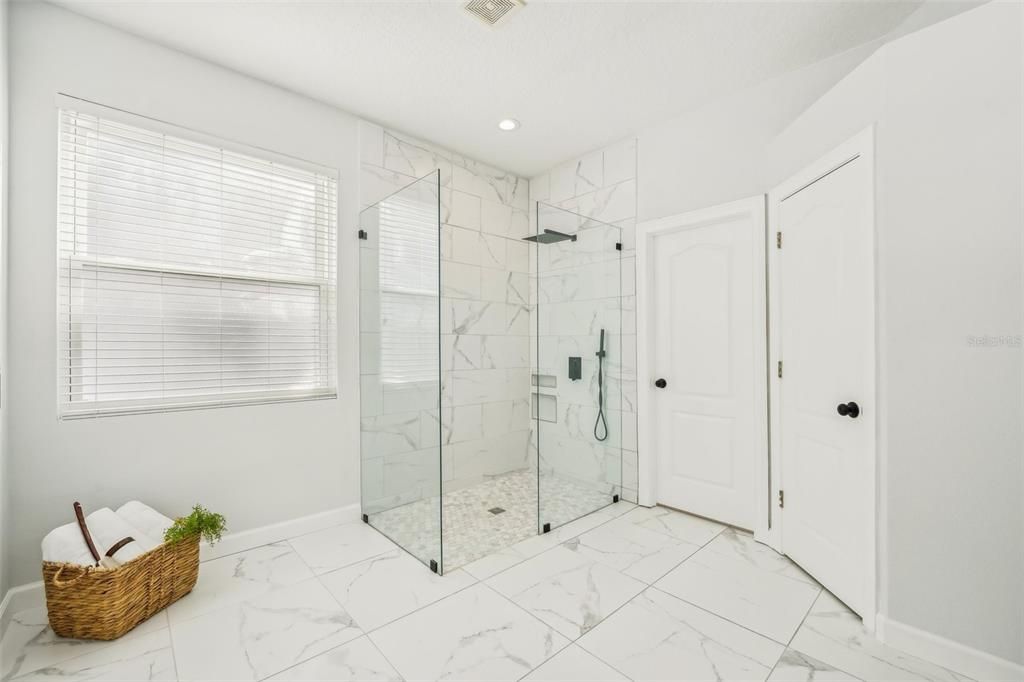 Stunning primary bath with a glass shower enclosure