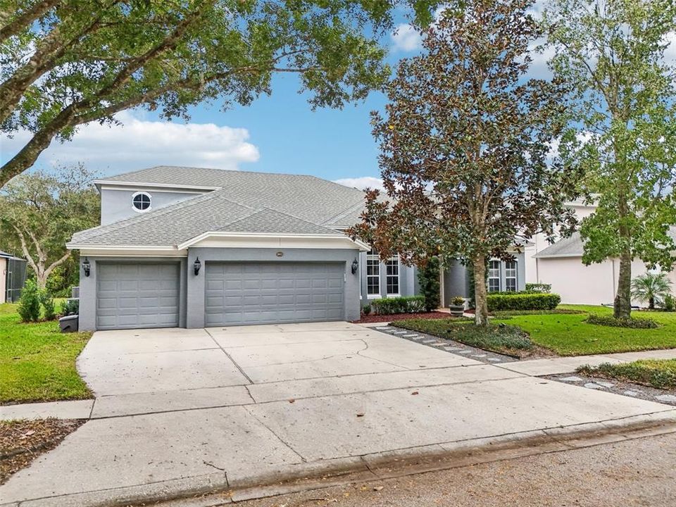 Extended 3 car garage with an oversized driveway