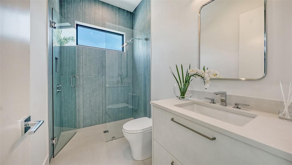 Pool bathroom accomodates guests with full shower