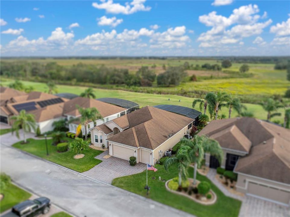 Home with golf course and open fields behind it