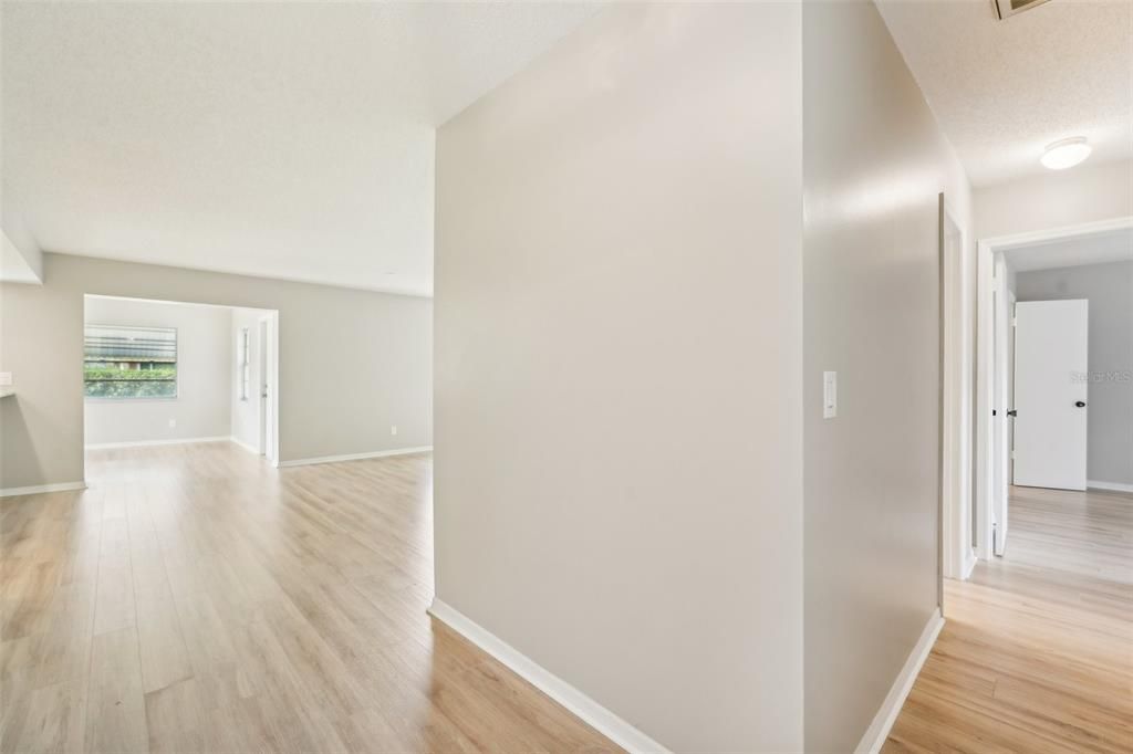 ENTRY LEADING TO LIVING ROOM AND HALL TO BEDROOMS