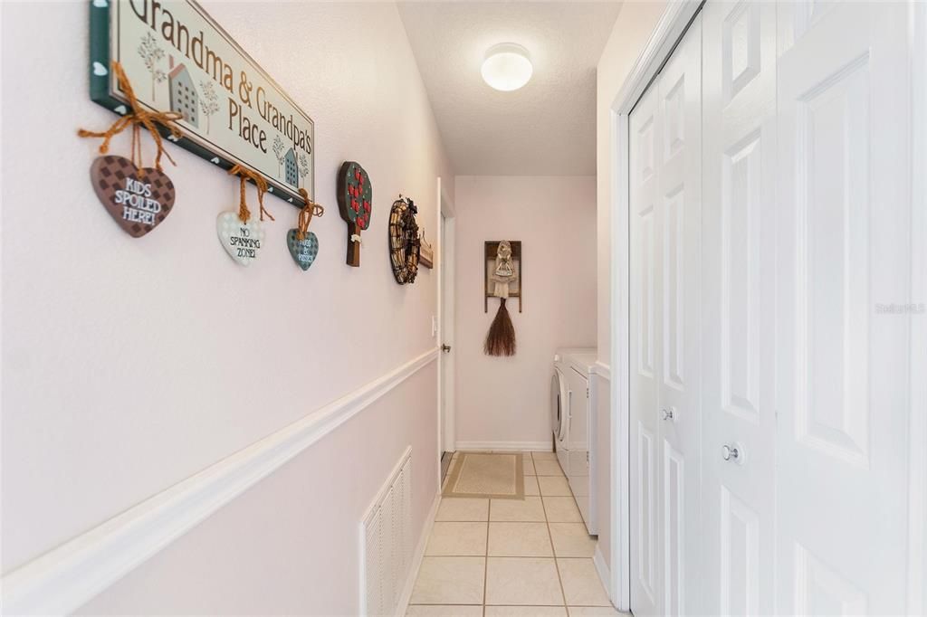 Corridor laundry area with closet pantry