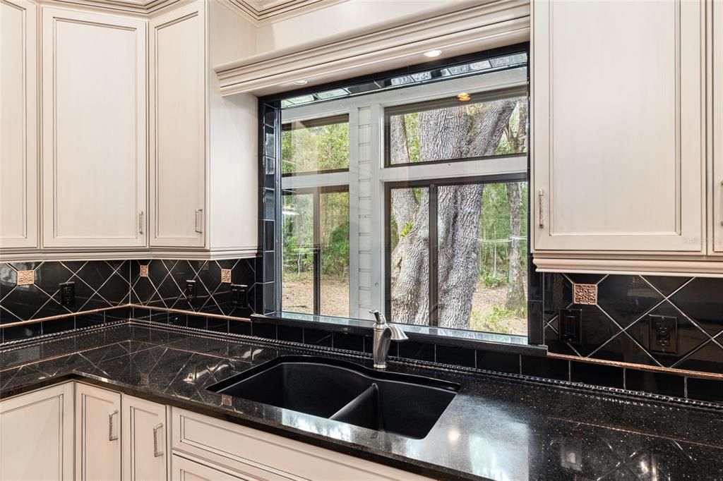 SINK OVERLOOKS EXPANSIVE YARD