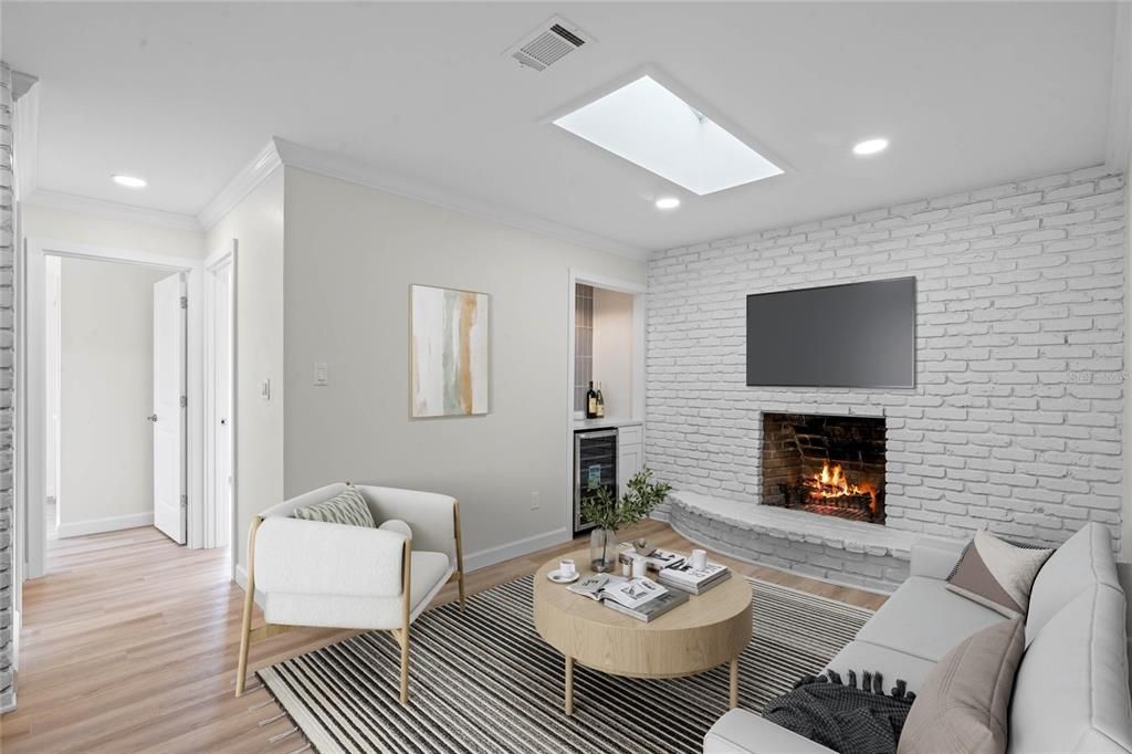 Cozy den/family room with wood burning fireplace and wine refrigerator