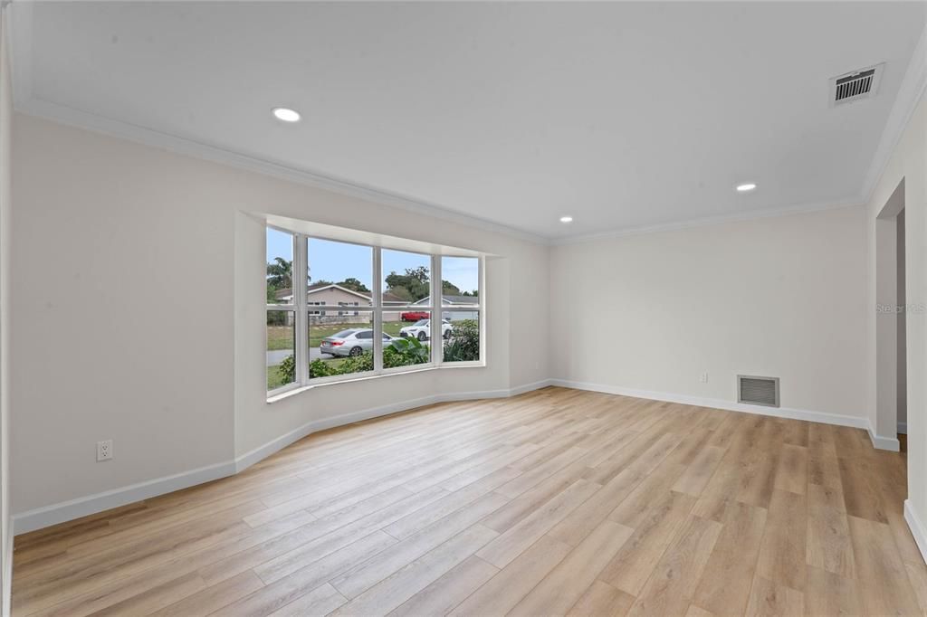 Living area at the front of the home with large windows