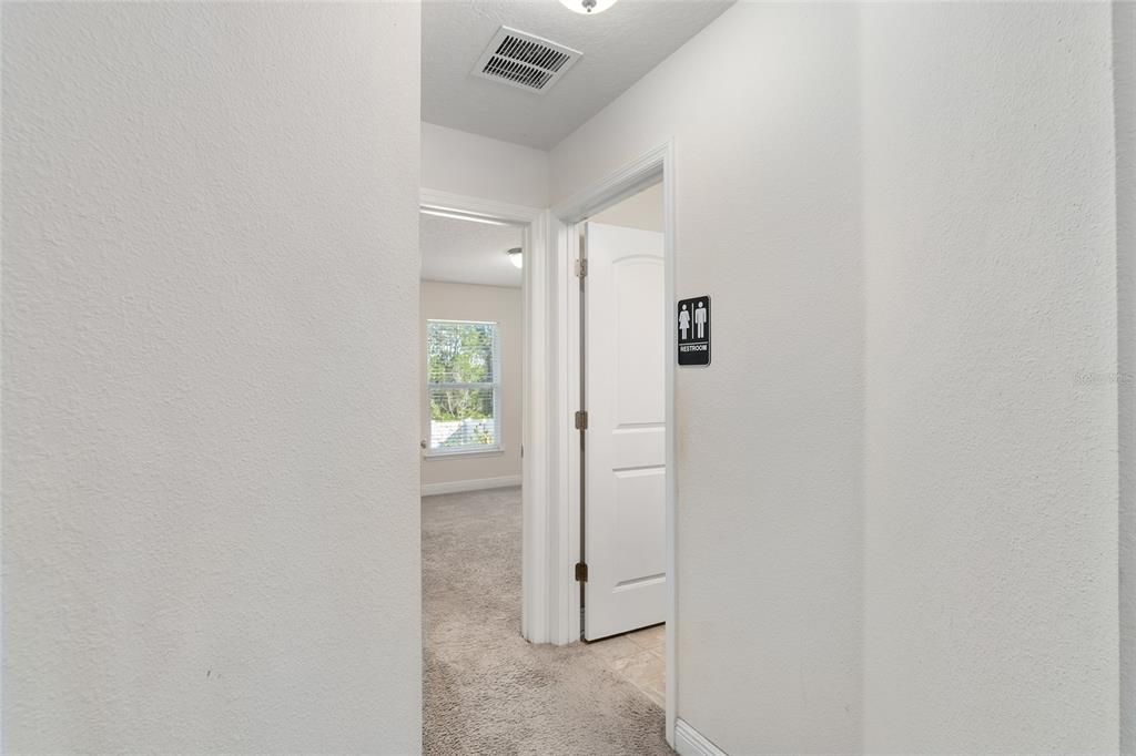 hallway to another bathroom and last bedroom