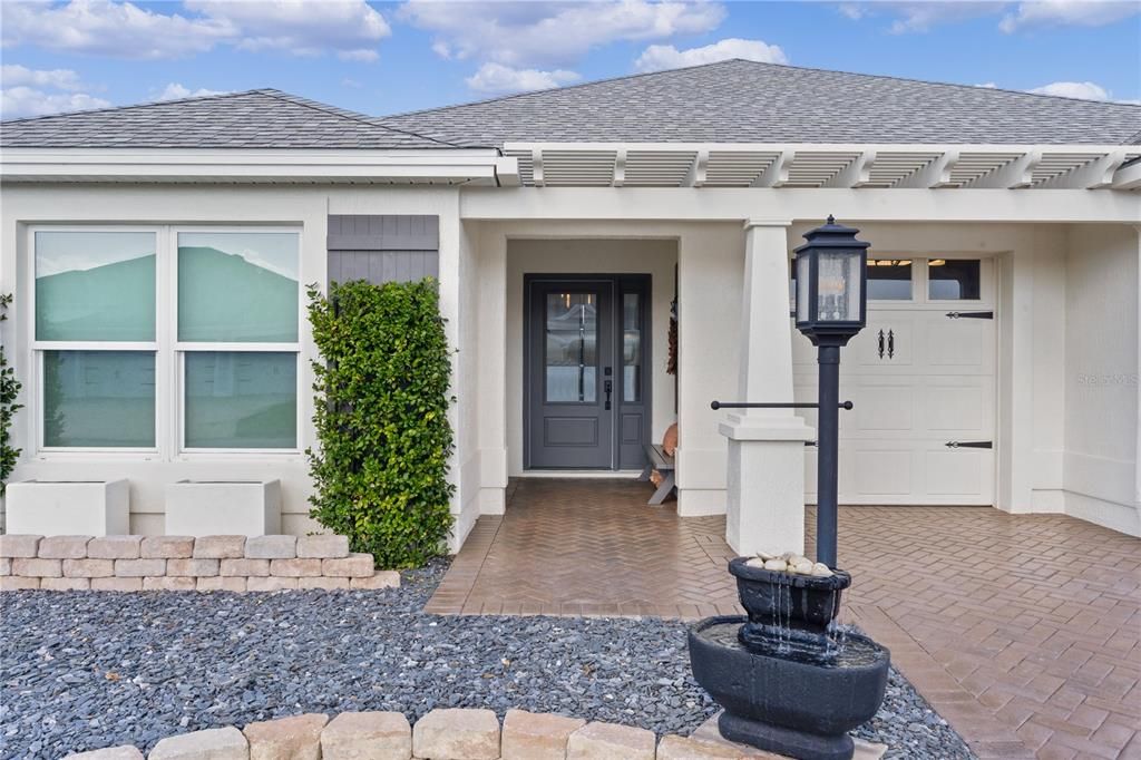 INVITING ENTRANCE WITH LOVELY CUSTOM DESIGN LEADED GLASS FRONT DOOR AND SIDELITE.