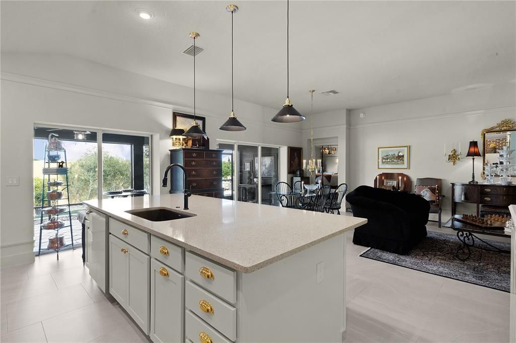 WHITE SHAKER CABINETRY WITH ELEGANT BRASS HARDWARE.