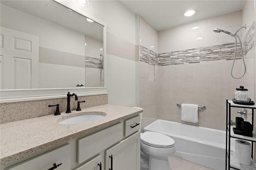 GUEST BATH FOR THIS ROOM WITH QUARTZ COUNTERS, AND TUB/SHOWER.